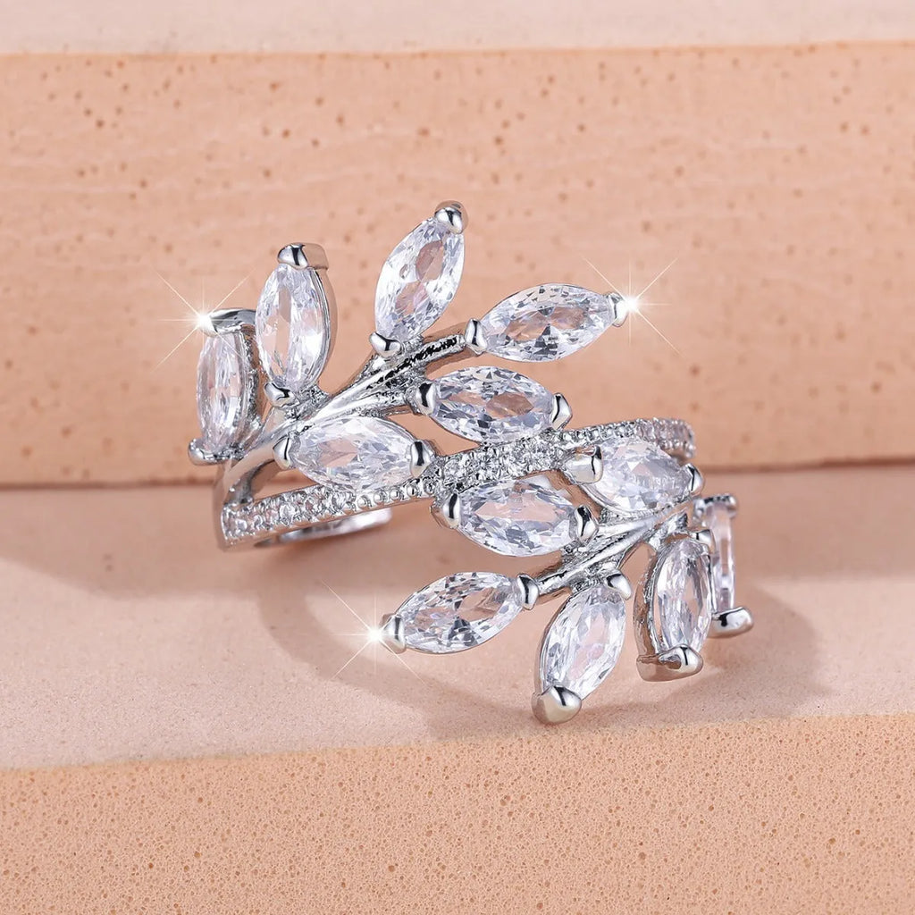 Adjustable copper leaf-shaped ring with a central horse eye zircon stone, shown in a rose gold finish.