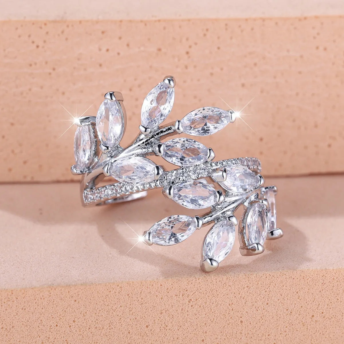Adjustable copper leaf-shaped ring with a central horse eye zircon stone, shown in a rose gold finish.