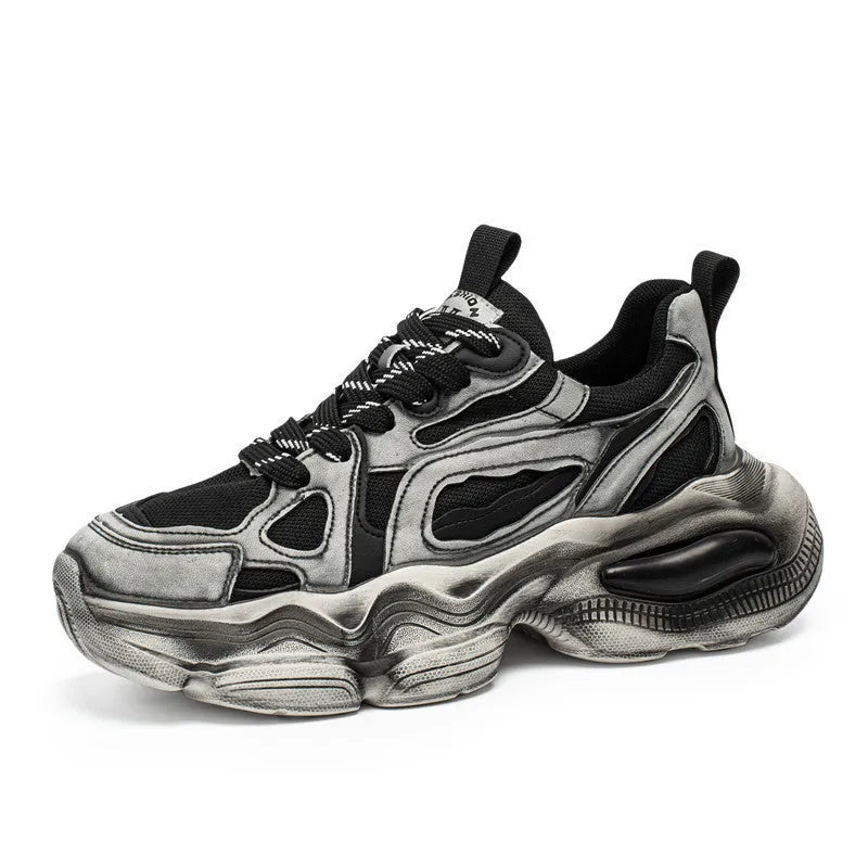 Men's black and grey mesh sneakers with a platform heel, round toe, and cross strap detail on a white background.