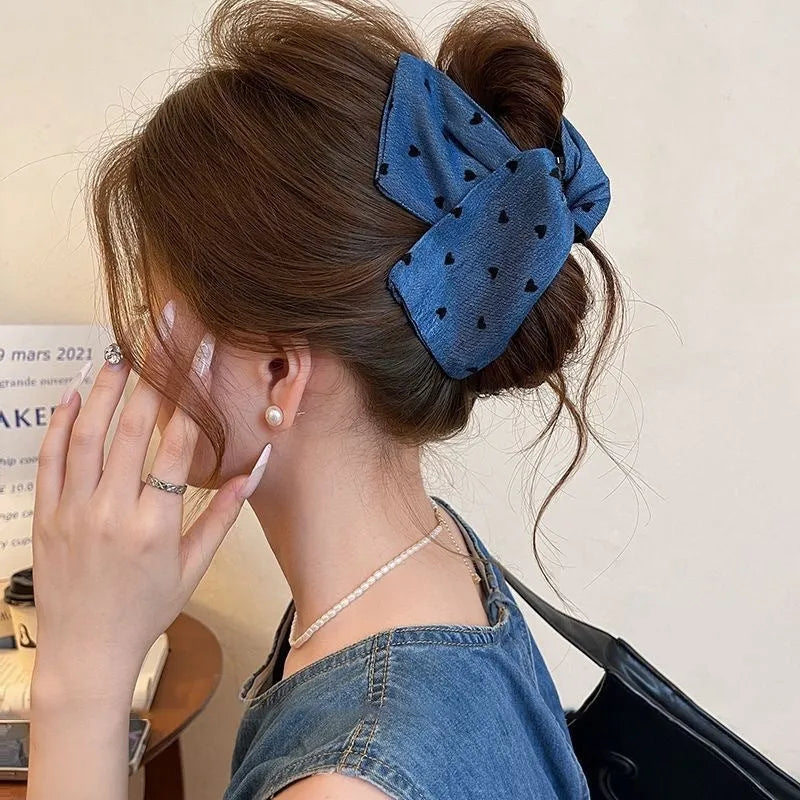 Women's denim bow hair clip with triangle grip, handmade from fabric and acrylic.