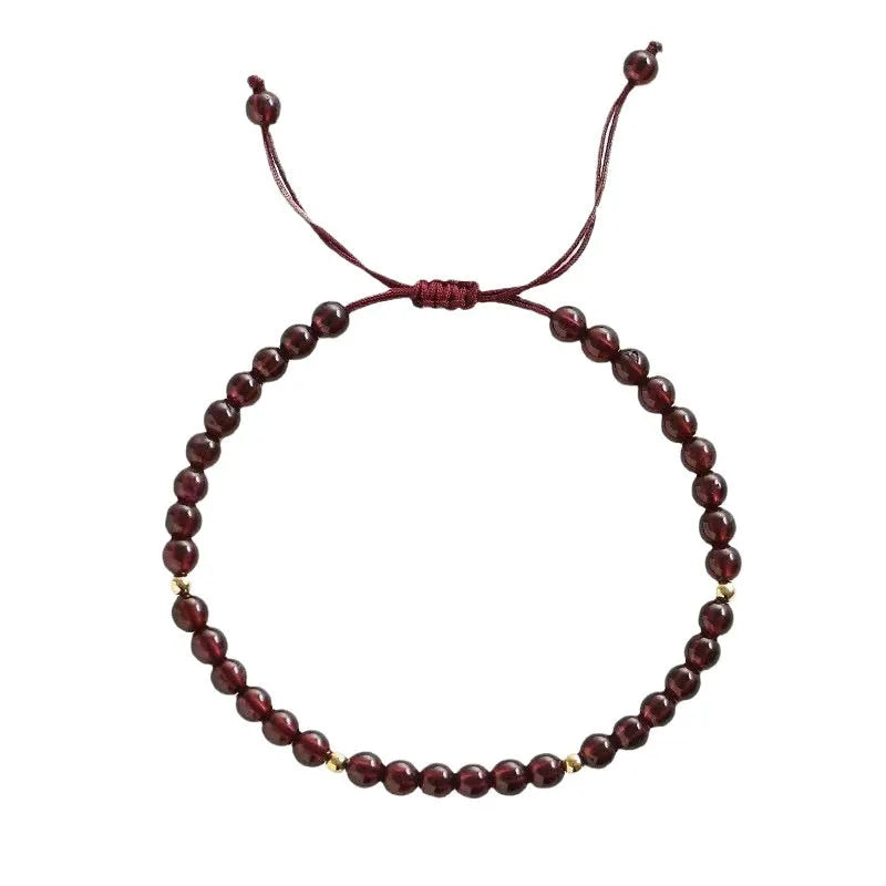 Hand-woven garnet red rope bracelet made from flexible wire, showing national tide style.