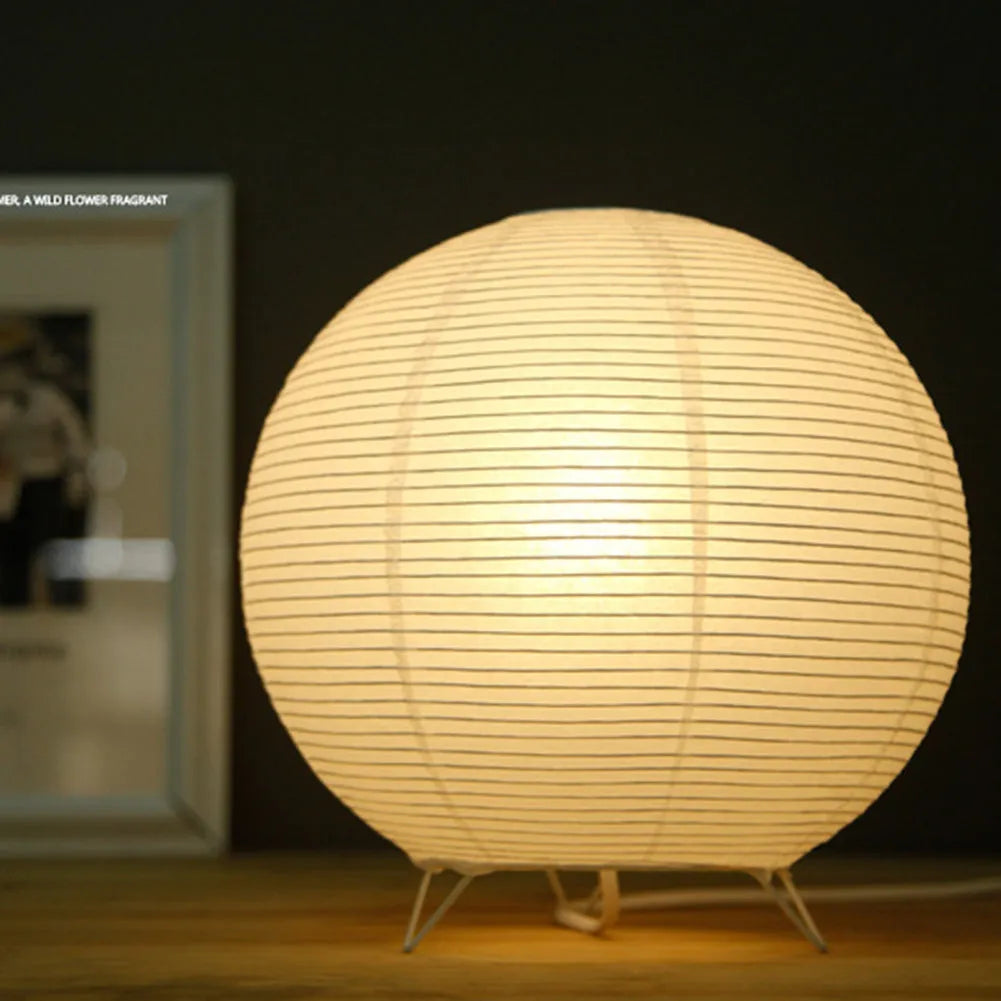 White rice paper table lamp with traditional handwork on bedside table