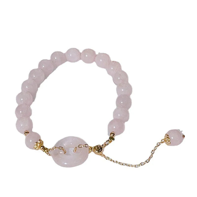 Pink crystal bracelet with peace buckle closure on woman's wrist