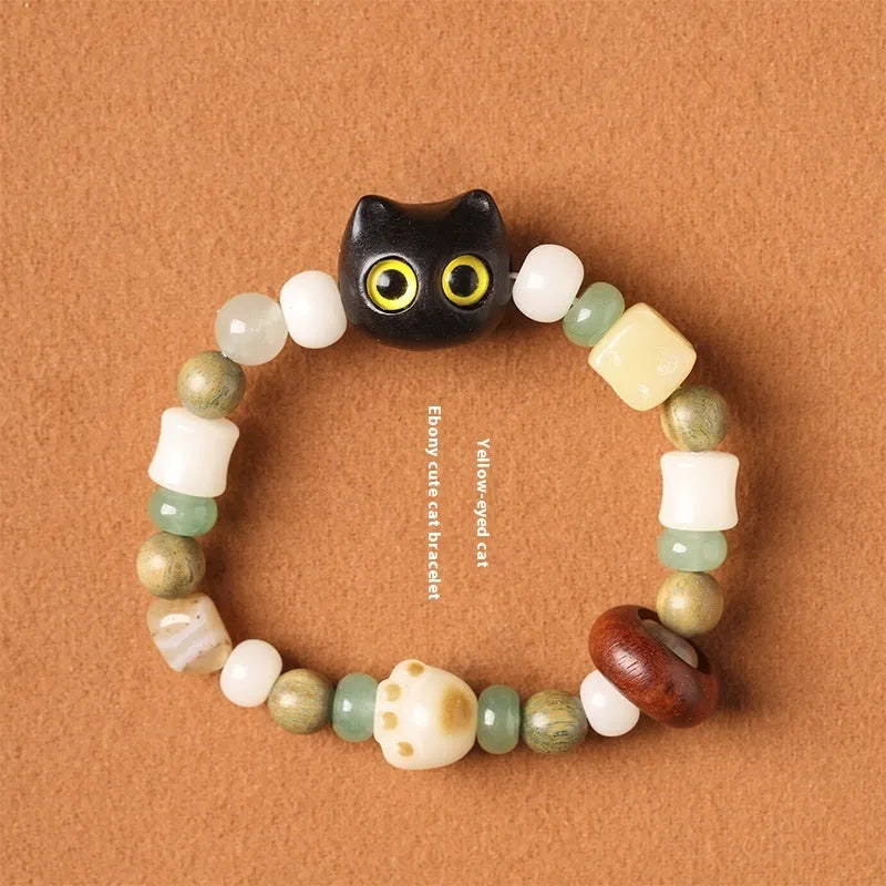 Hand-woven adjustable bracelet with bodhi seeds, jade beads, and a cartoon cat's paw guajacwood charm