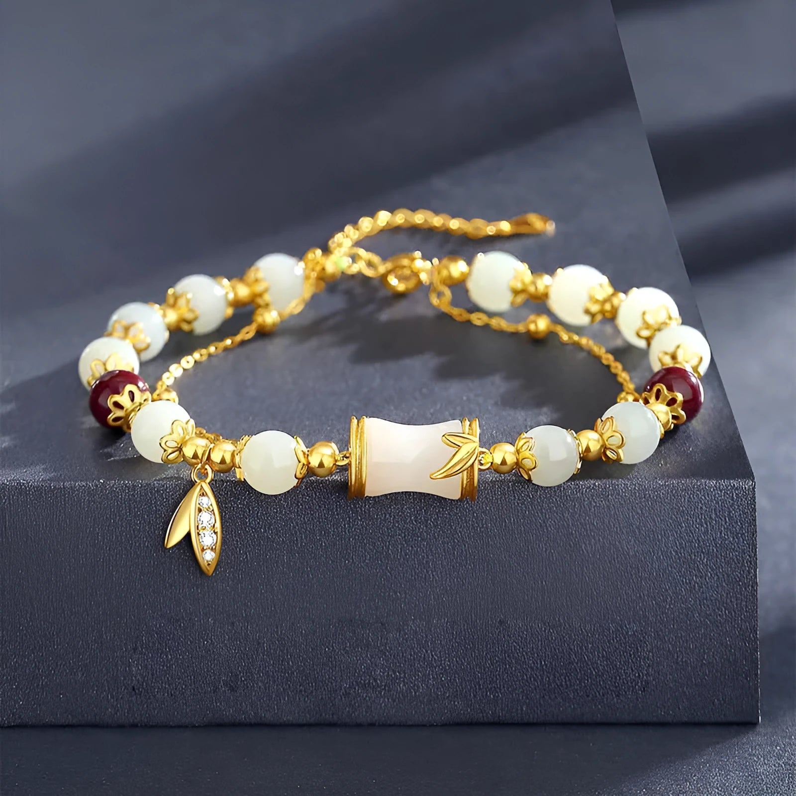 Bamboo-themed glass bracelet with coloured glaze beads and electroplated flower charm