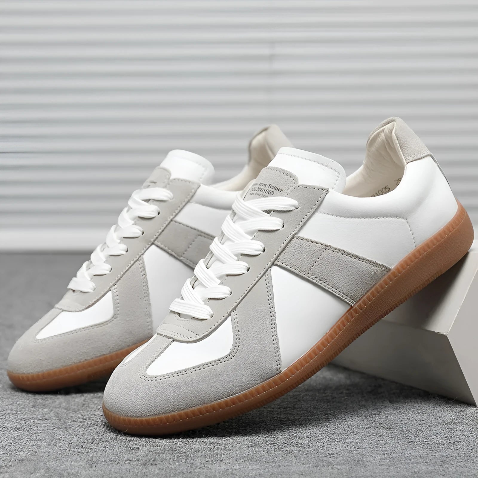 White Japanese-style retro low-top sneakers with mesh lining and a flat rubber sole on a plain background.