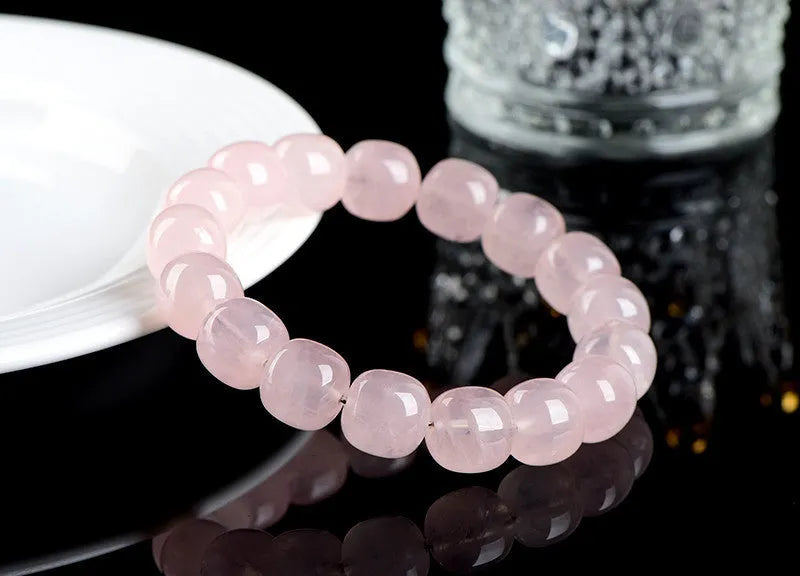 Pink natural bamboo crystal bracelet with geometric barrel beads on a wrist.