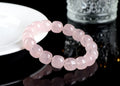Pink natural bamboo crystal bracelet with geometric barrel beads on a wrist.