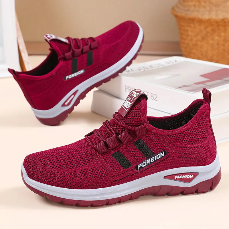 Low-top casual shoes with breathable mesh upper and flat PVC sole in black, grey, purple, or red.