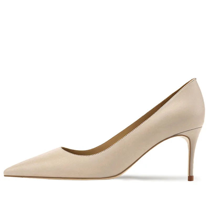Women's black pointed toe high heel shoes with soft rubber sole on wooden surface