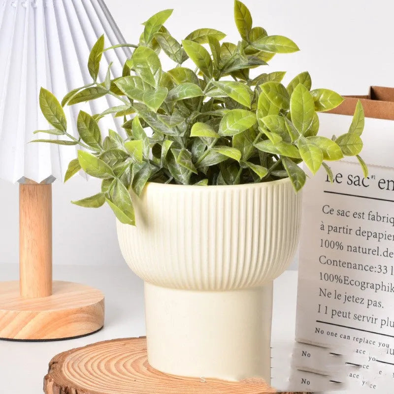 Roman column matte yellow ceramic flower pot on a table.