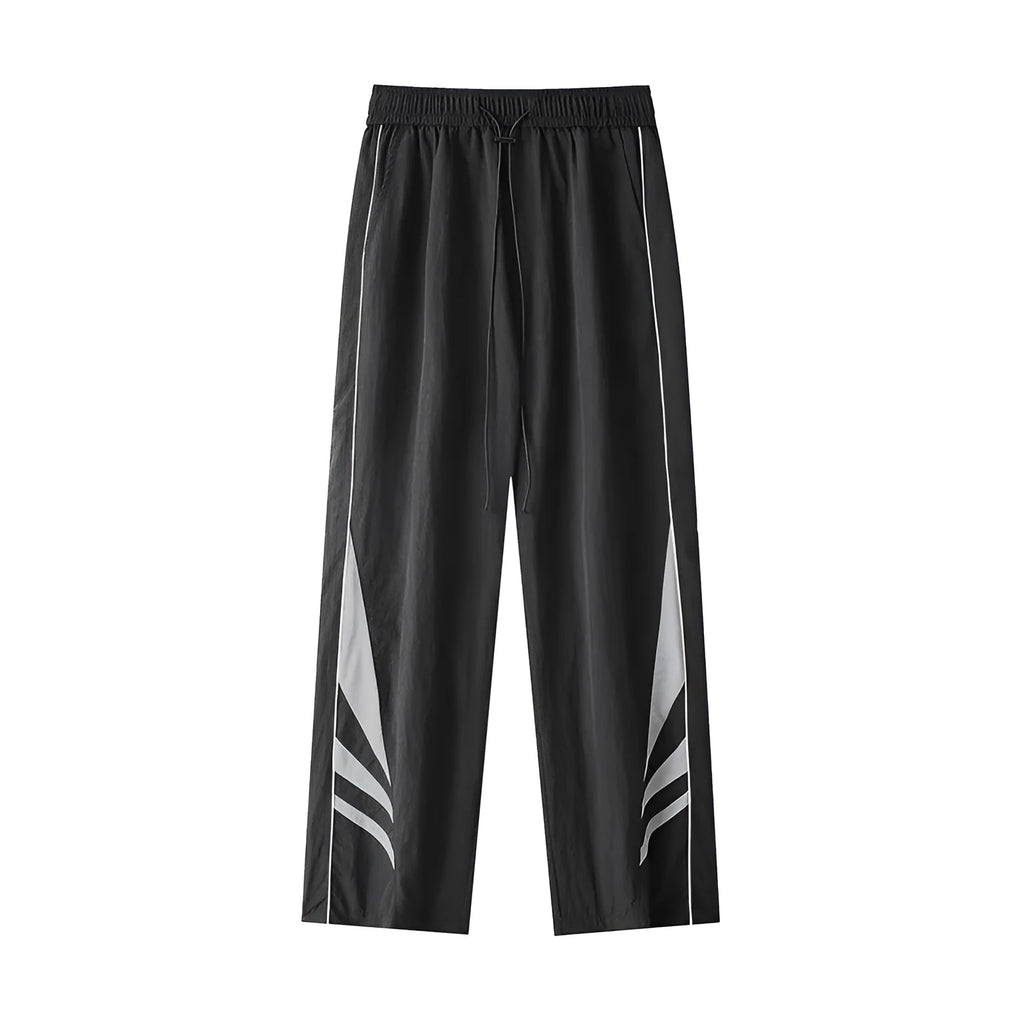 A man wearing black straight-leg loose-fit casual sports trousers for summer.