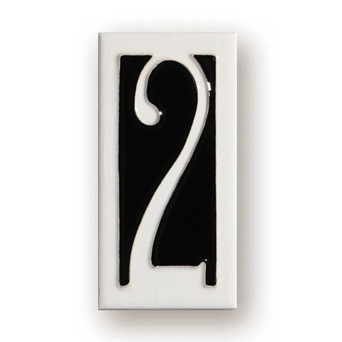 Handmade retro-style ceramic doorplate with fired enamel number, shown against a door.