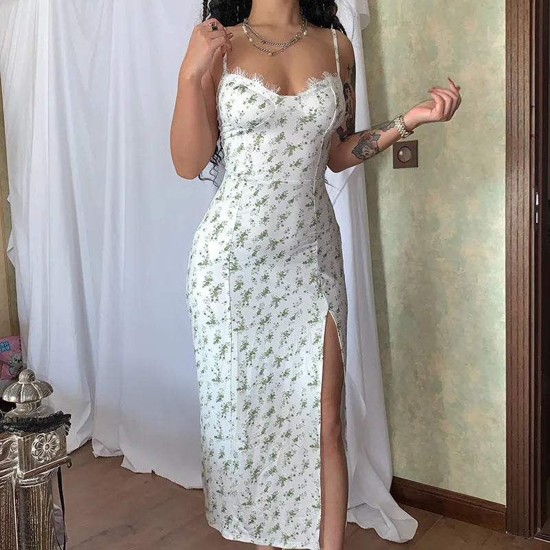 Blue long dress with white lace flower print, featuring a thigh slit and thin suspender straps.