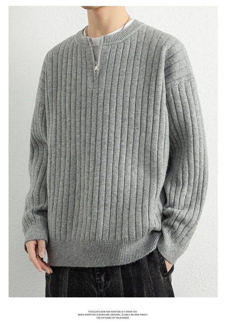 A grey men's textured knit half-zip pullover sweater on a hanger, showing the loose fit and long sleeves.