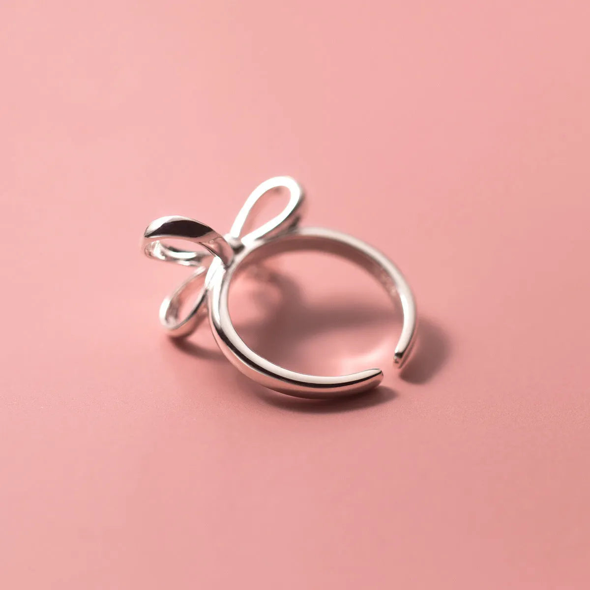 S925 silver bow ring with adjustable open band on hand, showing polished finish and Korean style design
