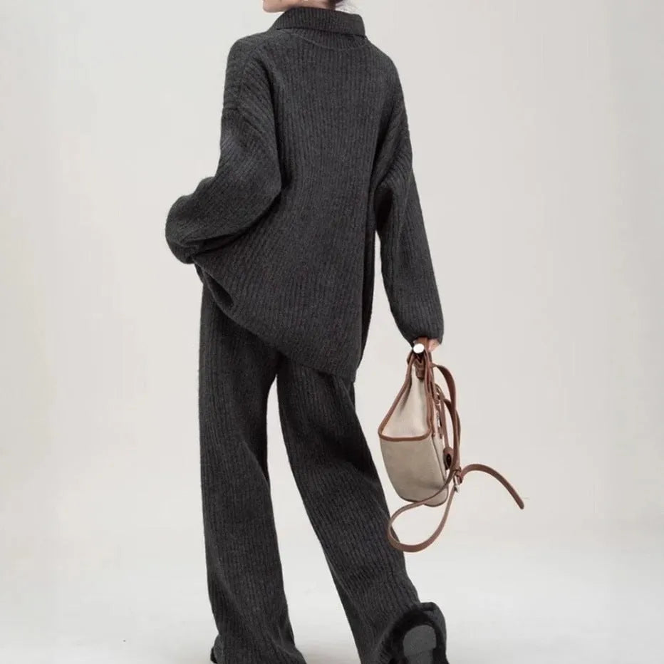 Women's beige knitted top and trousers two-piece set with long sleeves on a hanger.