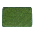 Green washable dog grass pee training mat with realistic lawn texture on a patio.