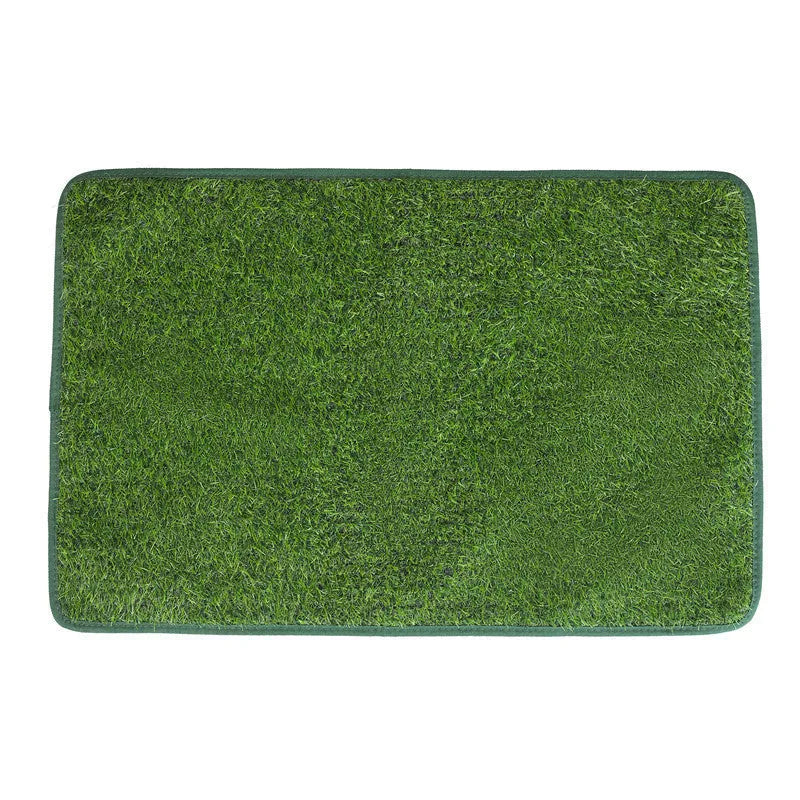 Green washable dog grass pee training mat with realistic lawn texture on a patio.
