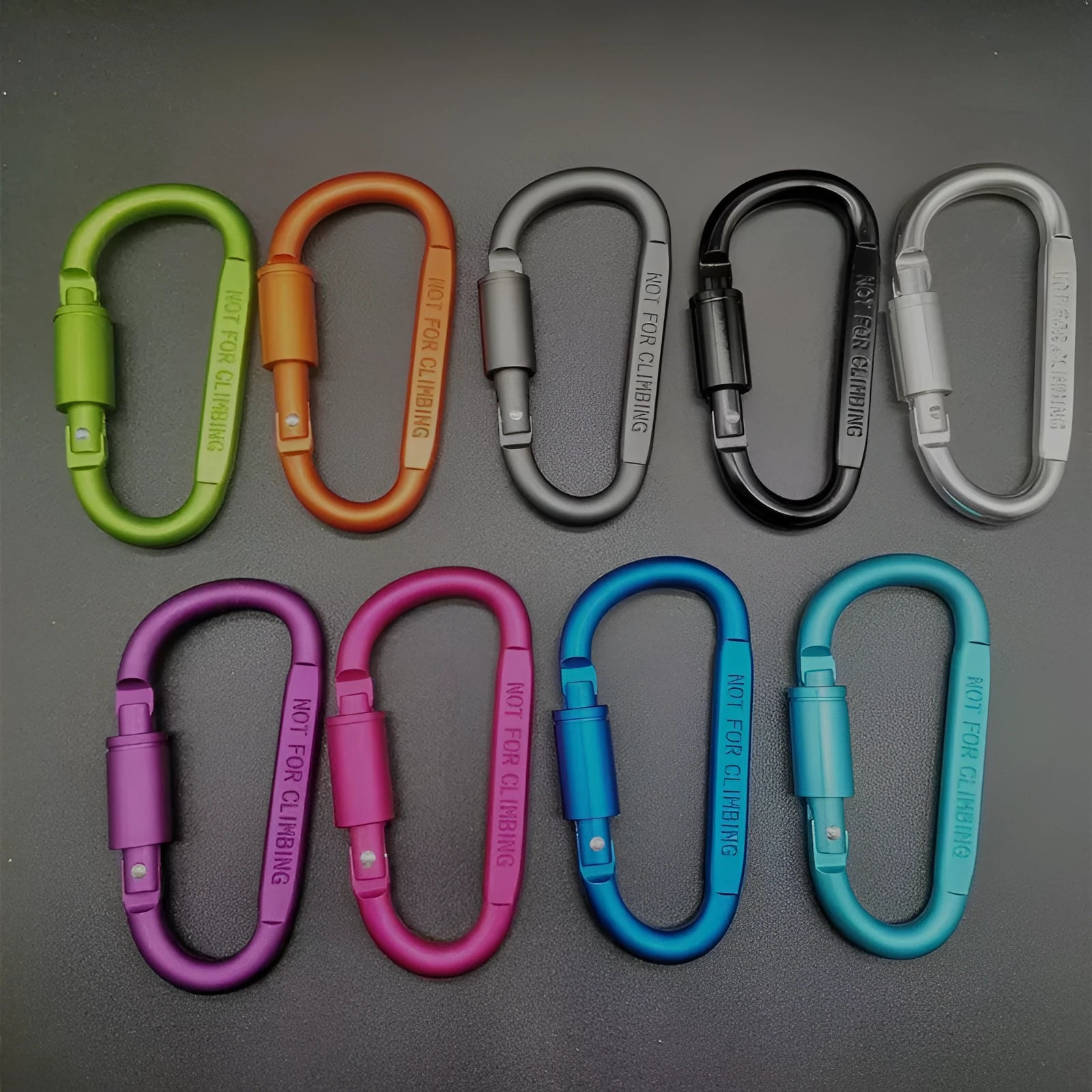 Silver D-shaped aluminium locking carabiner on a grey background.