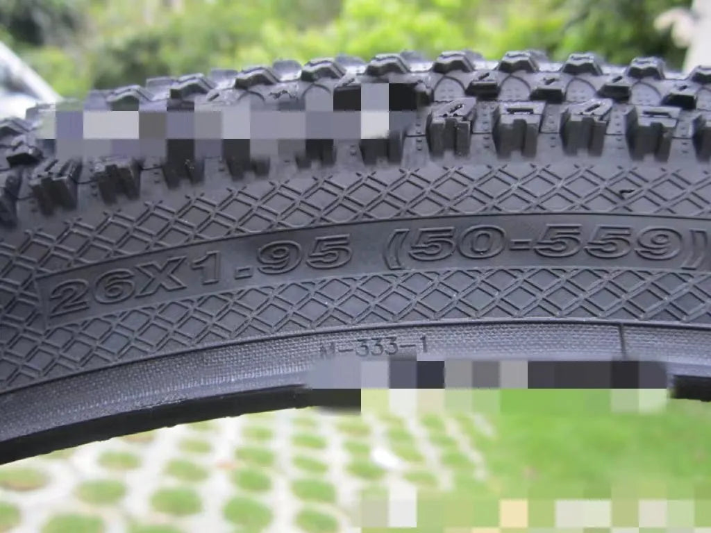 Ultralight black mountain bike tyre with white label option, showing tread pattern and size markings.
