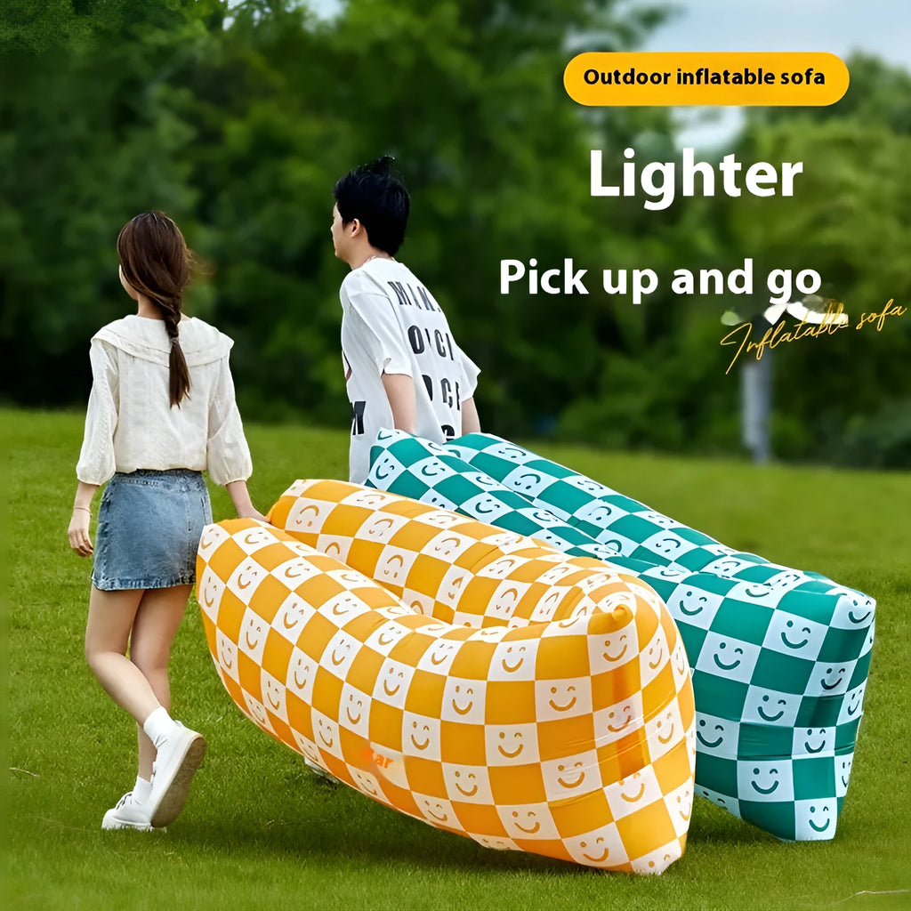 Inflatable lazy sofa in yellow smiling face tip colour, folded for transport with one-minute inflation valve visible