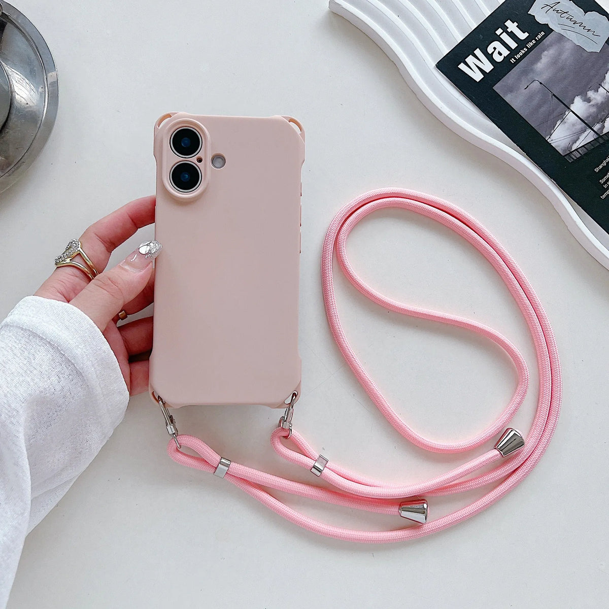Four-corner cross lanyard liquid silicone phone case for Apple iPhone 16 Pro Max in black with detachable crossbody strap