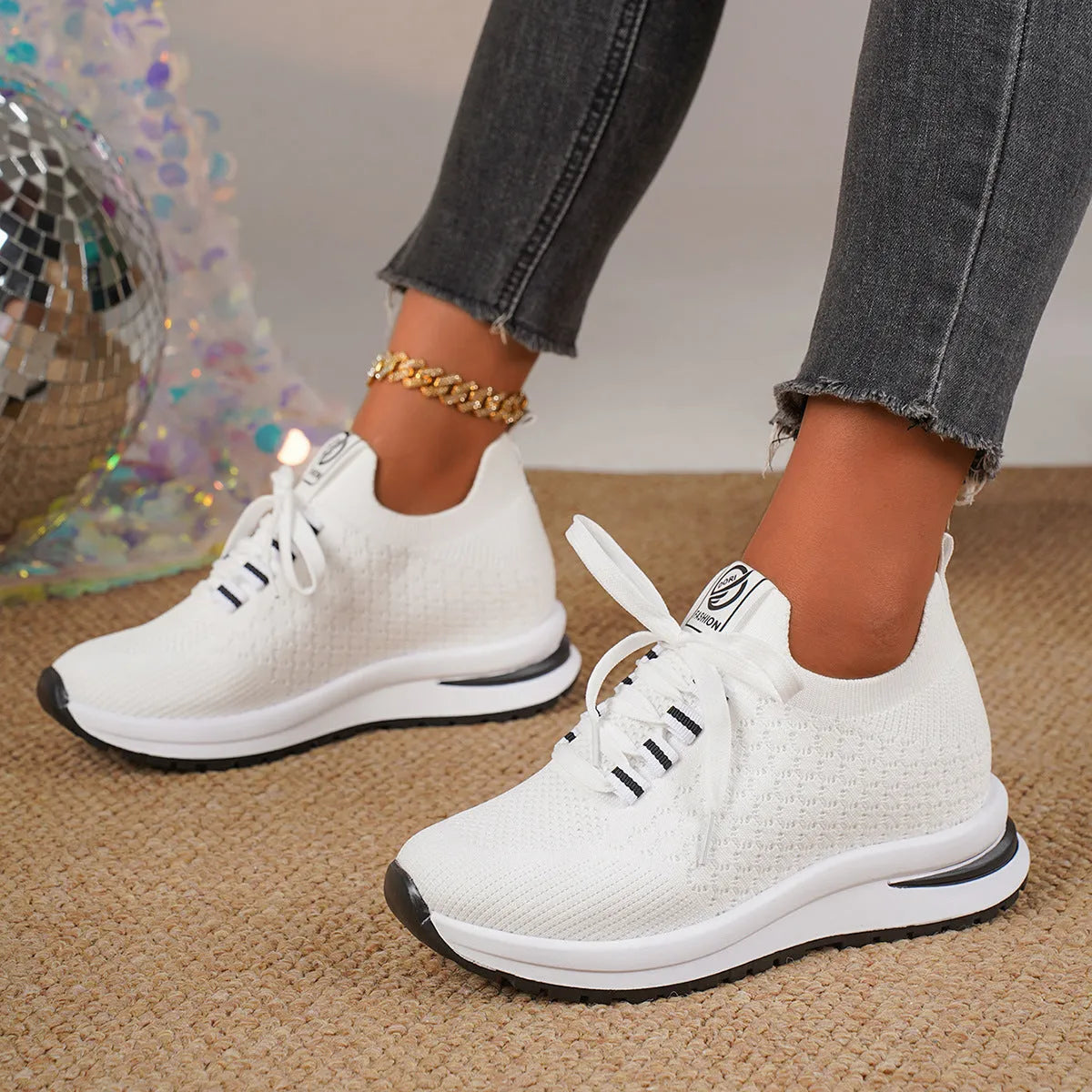 Women's black platform sneakers with mesh upper and lace-up front on flat rubber sole