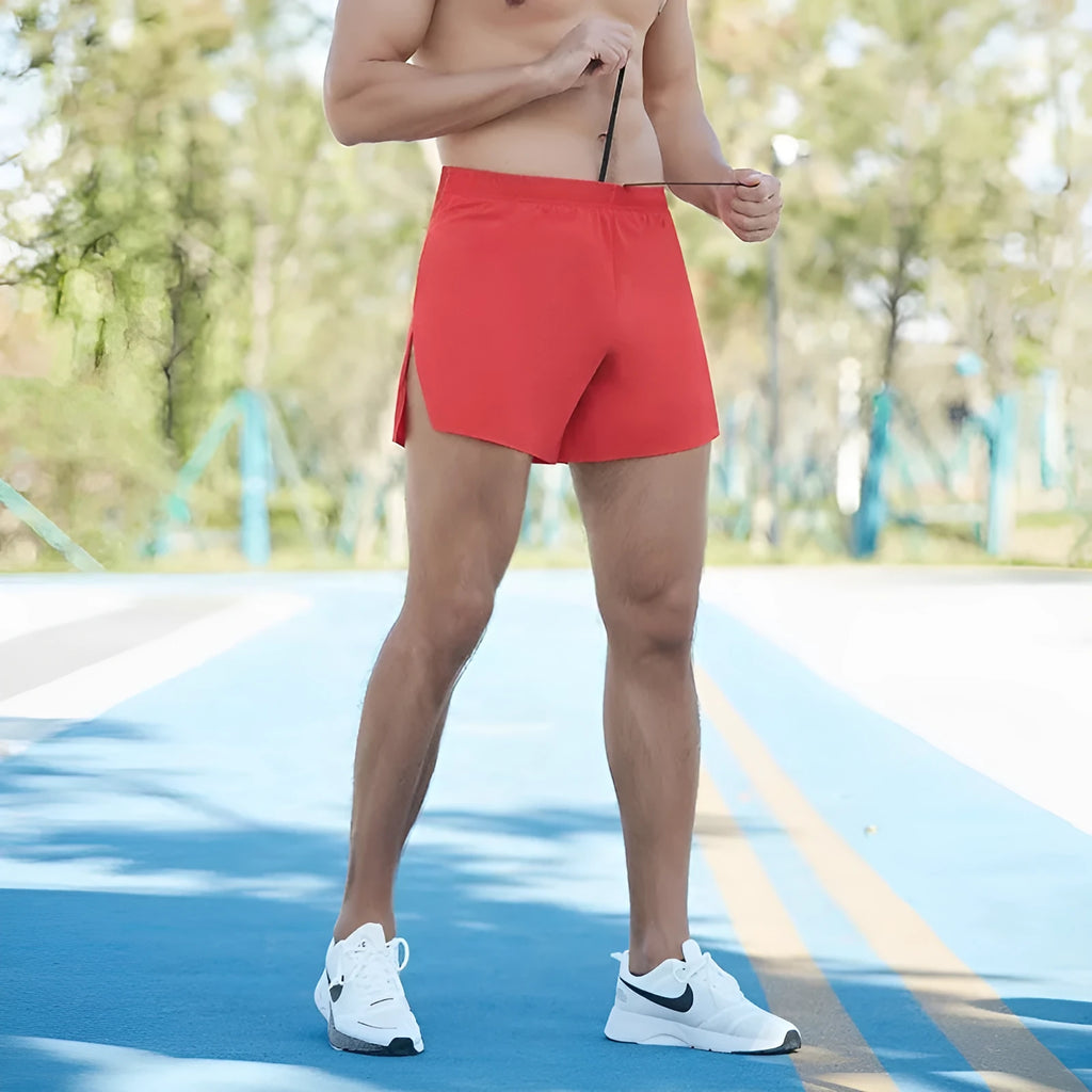 Man wearing navy blue high-waist off-road running shorts with a loose, breathable cut during a run.