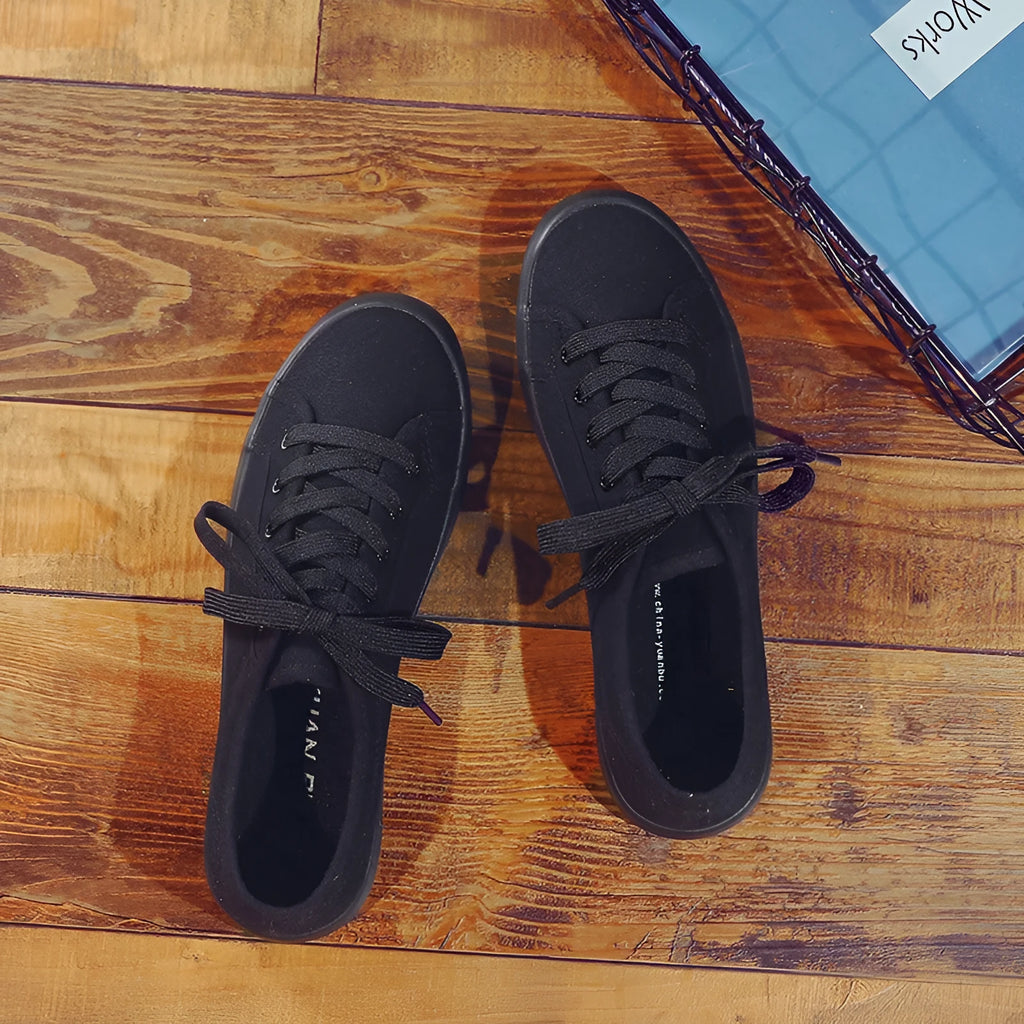 All black Korean-style women's canvas flat shoes with lace-up front and rubber sole
