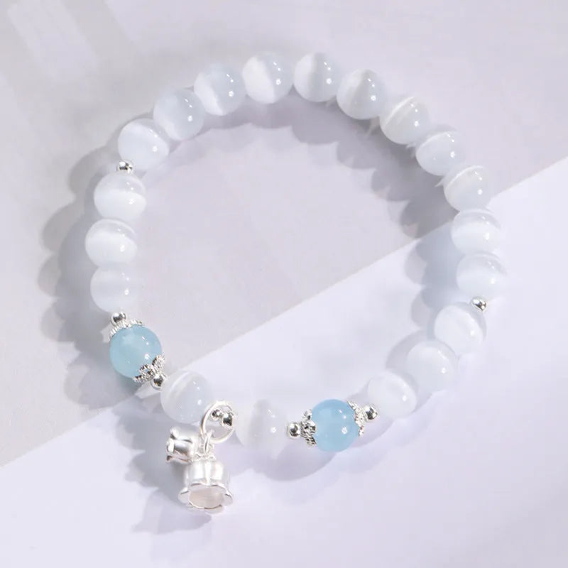 Close-up of electroplated opal cat's eye beaded bracelet for women with diamond-shaped charm