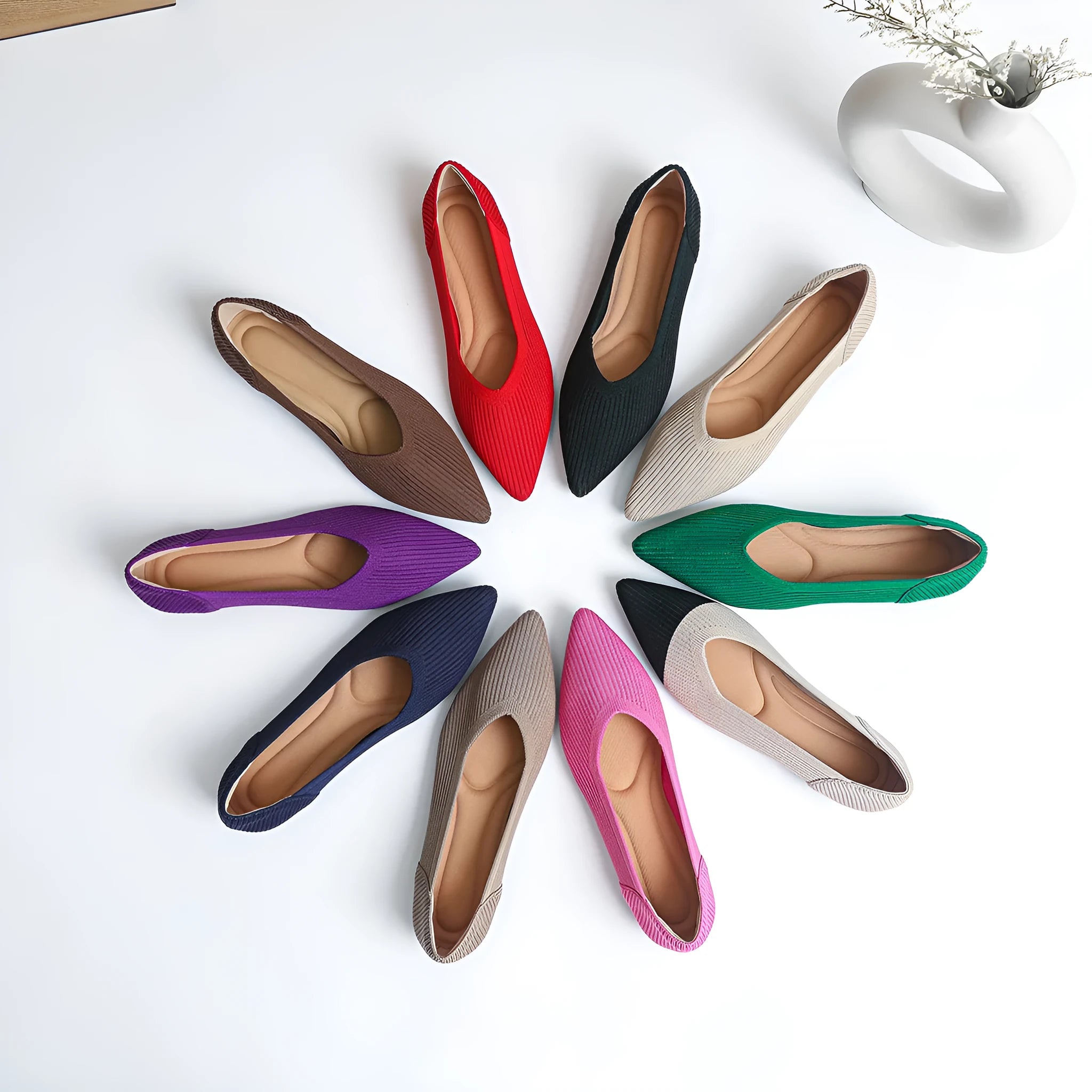 Women's apricot-coloured knit flat pumps with a pointed toe and slip-on design on a white background.