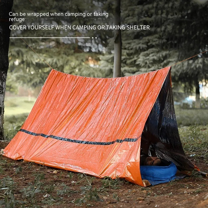 Orange portable disaster relief tent kit with sleeping bag and raincoat laid out