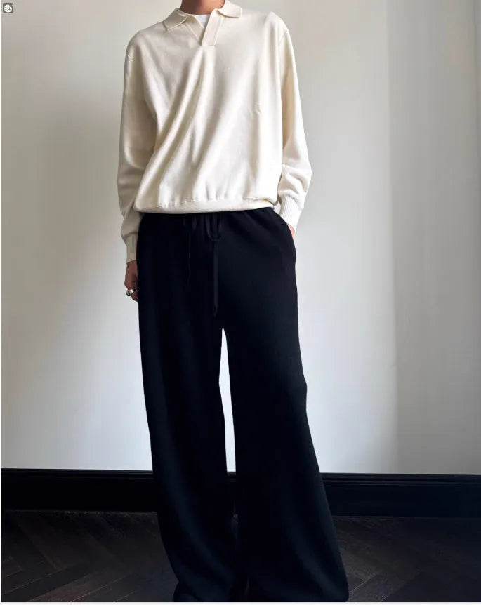 Milky white pure wool lapel collar polo sweater laid flat, showing loose fit and long sleeves.