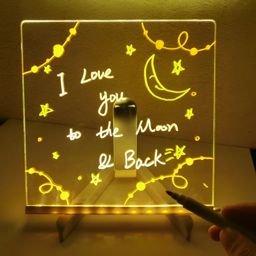 Acrylic DIY LED message board on a bracket, glowing softly with handwritten notes, alongside white and colourful pens.