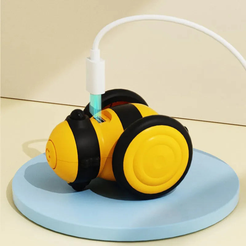 Bee-shaped electric cat car toy with feather teaser stick in pink and yellow colour options