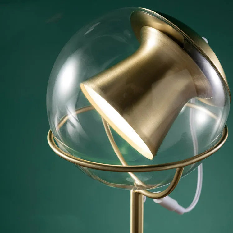 Glass lampshade desk lamp with touch dimming control on wooden surface