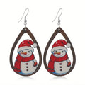 Pair of wooden geometric Christmas earrings with Santa Claus design in red and green colours.