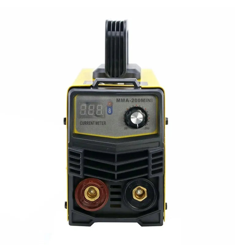 Household MMA-200MIN 220V DC inverter welding machine with cables, tongs, clamp, and face shield on a workbench.
