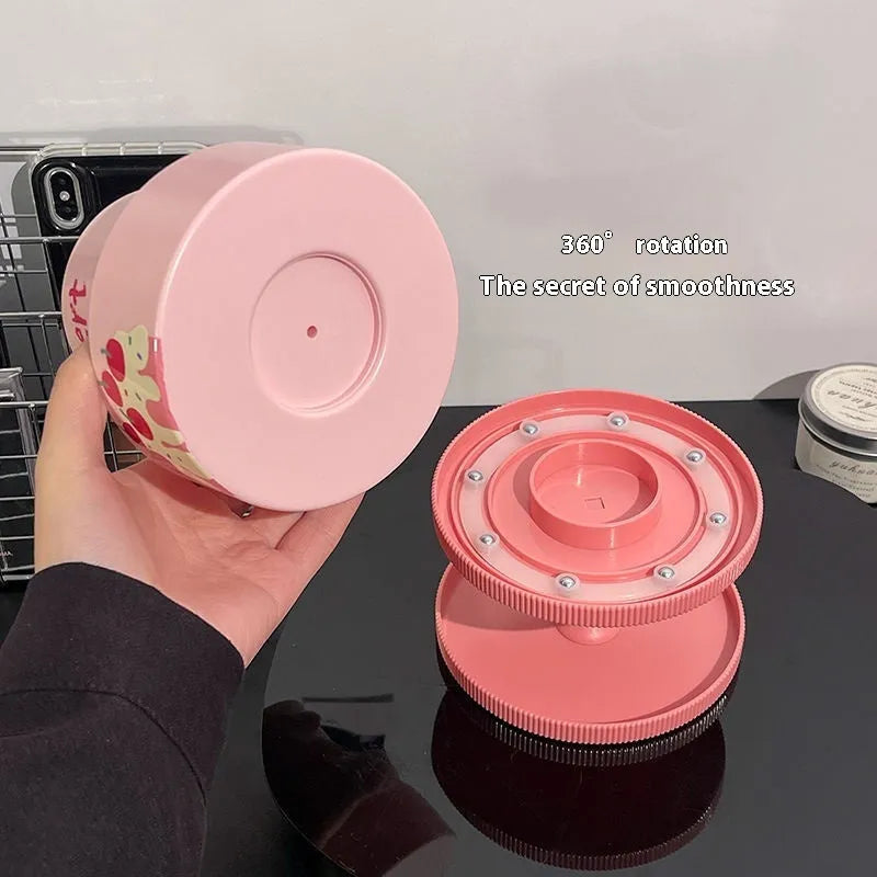 Beige rotating cosmetic brush storage barrel with open lid showing internal organiser rack