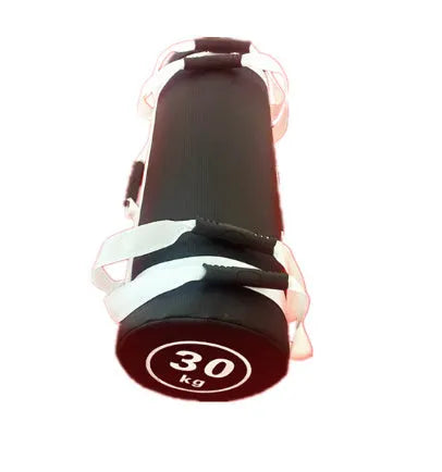 Flat white PVC fitness sandbag on gym floor, showing size and sturdy handles for weight training.