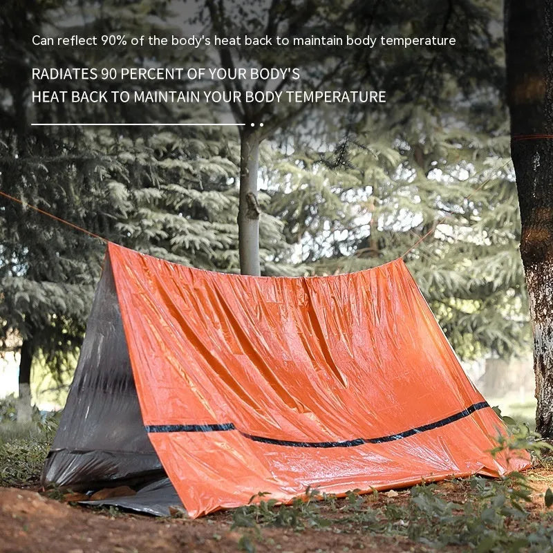 Orange portable disaster relief tent kit with sleeping bag and raincoat laid out