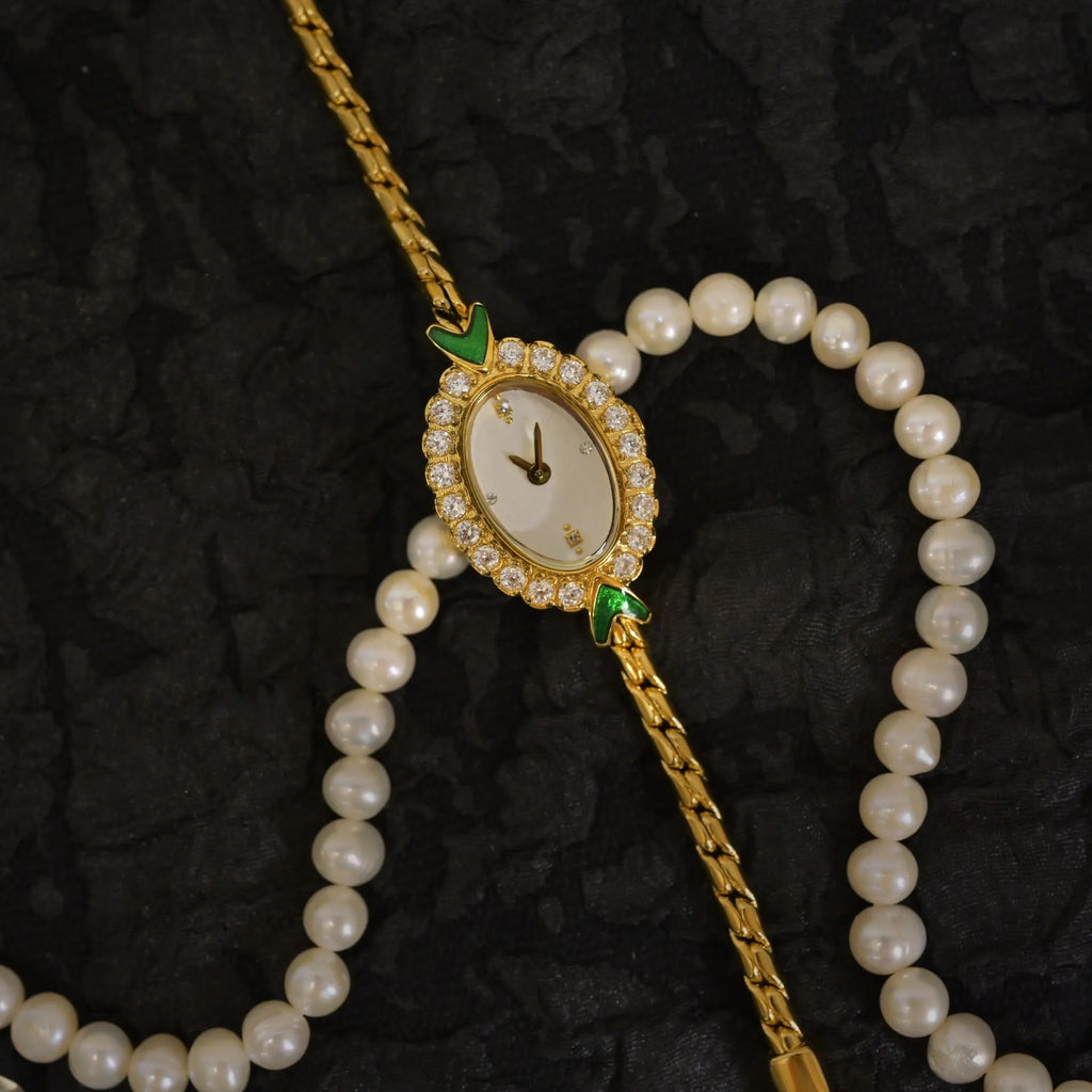 European small gold women's watch with handmade rhinestone inlay and adjustable strap on light background