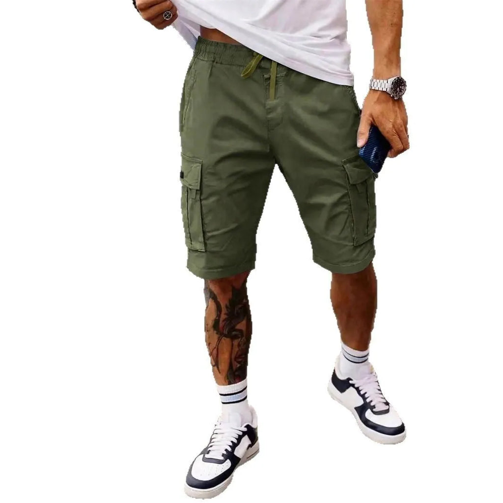 Man wearing loose grey cropped workwear shorts with a straight leg and micro-elastic fabric.
