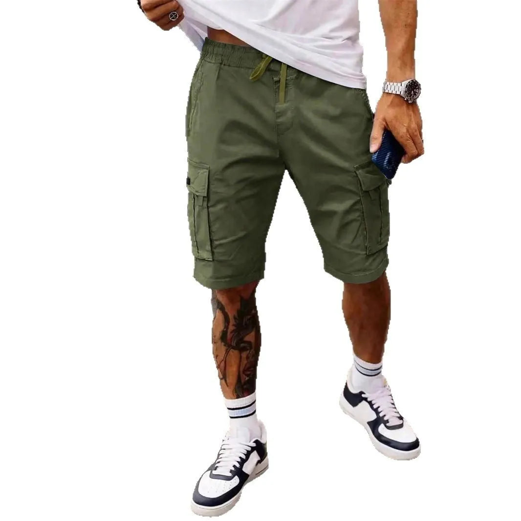 Man wearing loose grey cropped workwear shorts with a straight leg and micro-elastic fabric.