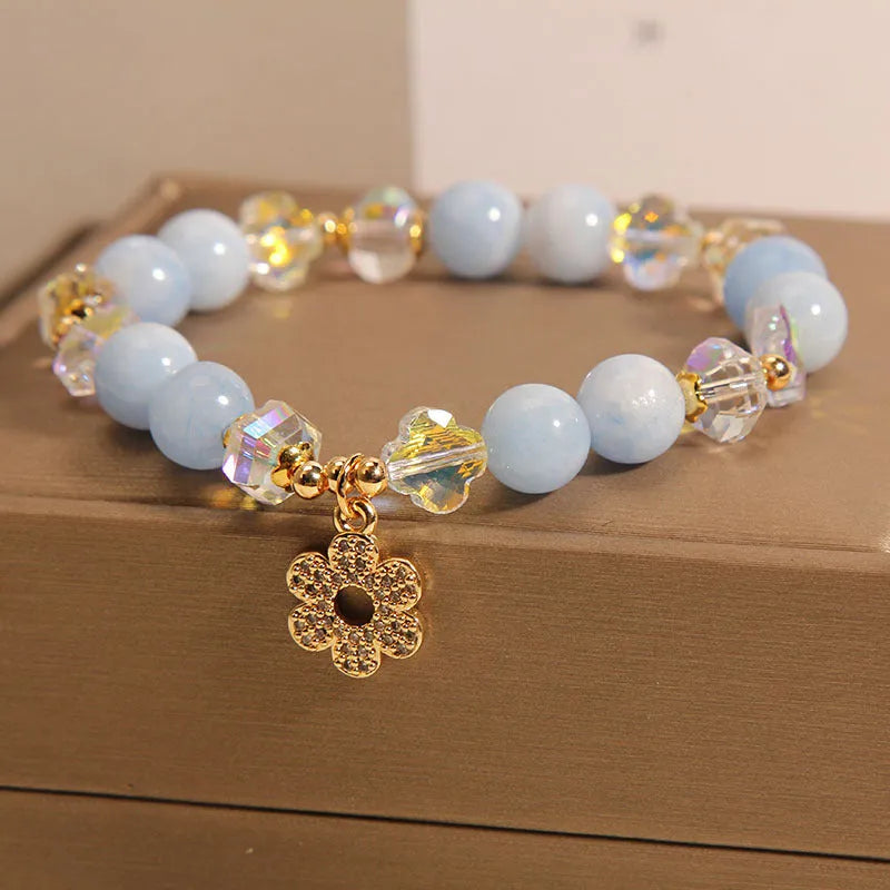 Women's aquamarine crystal bracelet with four-leaf clover charm and pearl decorative accents
