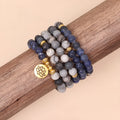 Blue multi-layer bracelet with patterned network stone beads on an alloy base.