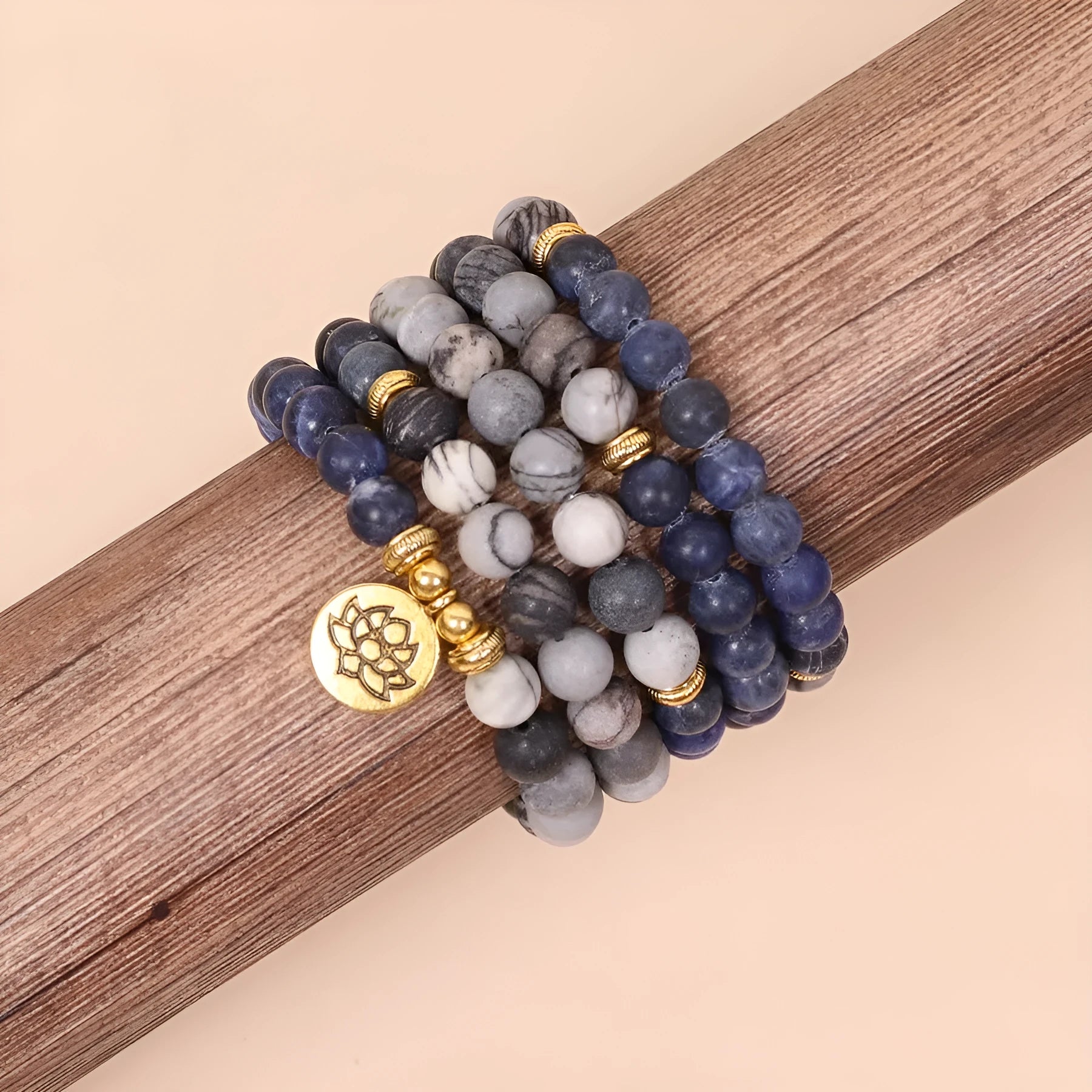 Blue multi-layer bracelet with patterned network stone beads on an alloy base.