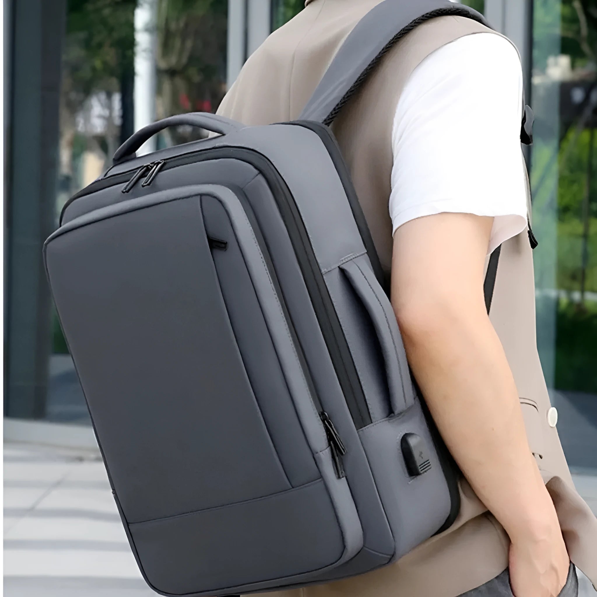 Men's black waterproof backpack with curved shoulder straps and 20-35L capacity for business travel