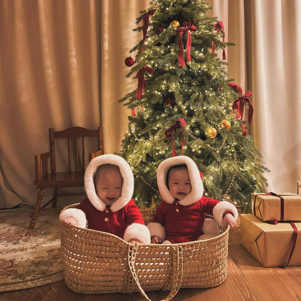 Red hooded Christmas baby romper onesie made of cotton with long sleeves and triangle style on a white background